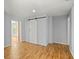 Bedroom features wood floors, closet, and a door leading to the entryway at 14171 Sw 8Th Ave, Ocala, FL 34473