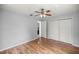 Bedroom features wood floors, closet, and a door leading to the entryway at 14171 Sw 8Th Ave, Ocala, FL 34473