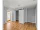 Bedroom features wood floors, closet, and a door leading to the entryway at 14171 Sw 8Th Ave, Ocala, FL 34473