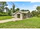 Single-story home with a stucco exterior, lawn, and a driveway at 14171 Sw 8Th Ave, Ocala, FL 34473