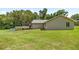 Side view of home highlighting the screened-in porch and backyard at 14171 Sw 8Th Ave, Ocala, FL 34473
