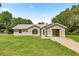 Inviting single-story home with landscaped lawn, garage, and charming architectural details at 14171 Sw 8Th Ave, Ocala, FL 34473