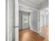 Hallway with exterior exit, French doors, and light-toned wood-look flooring at 14171 Sw 8Th Ave, Ocala, FL 34473