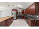 Modern kitchen features a center island, stainless appliances, and dark wood cabinetry at 14171 Sw 8Th Ave, Ocala, FL 34473