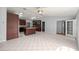 Open kitchen featuring an island, tile flooring, dark cabinets, and bright lighting at 14171 Sw 8Th Ave, Ocala, FL 34473