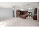 Spacious kitchen with an island, ceiling fan, stainless steel refrigerator, and tiled floor at 14171 Sw 8Th Ave, Ocala, FL 34473