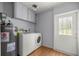 Laundry room with washer, dryer, water heater, overhead cabinets, and access to the outdoors at 14171 Sw 8Th Ave, Ocala, FL 34473