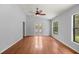 Bright living room boasts hardwood floors, a ceiling fan, and large windows at 14171 Sw 8Th Ave, Ocala, FL 34473