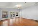 Well-lit living room with hardwood flooring, ceiling fan, and French doors to the yard at 14171 Sw 8Th Ave, Ocala, FL 34473