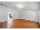 Living room with hardwood floors, a ceiling fan, and an entryway to the kitchen at 14171 Sw 8Th Ave, Ocala, FL 34473