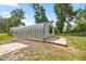 Metal quonset style outbuilding with a concrete slab and exterior window at 14171 Sw 8Th Ave, Ocala, FL 34473