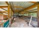 Interior of an outbuilding with wood supports and metal fencing at 14171 Sw 8Th Ave, Ocala, FL 34473