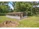 Exterior of a metal and wood framed outbuilding with screened windows at 14171 Sw 8Th Ave, Ocala, FL 34473