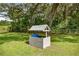 Exterior wishing well feature in the yard with blue container at 14171 Sw 8Th Ave, Ocala, FL 34473