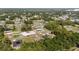 An aerial view highlights a neighborhood with tree-lined streets, and community design at 15087 Sw 43Rd Ct, Ocala, FL 34473