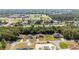 A stunning aerial view of homes near a school with well-maintained lawns and lush landscaping at 15087 Sw 43Rd Ct, Ocala, FL 34473