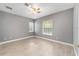 Bright bedroom with neutral paint, two windows, laminate flooring, and a ceiling fan at 15087 Sw 43Rd Ct, Ocala, FL 34473