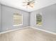 Bedroom with neutral paint, ceiling fan, laminate flooring, and bright windows at 15087 Sw 43Rd Ct, Ocala, FL 34473