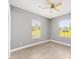 Well-lit bedroom features a ceiling fan, and two large windows with natural light at 15087 Sw 43Rd Ct, Ocala, FL 34473