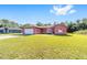 Single-Gathering home with a sprawling front yard, a large driveway and a two-car garage at 15087 Sw 43Rd Ct, Ocala, FL 34473
