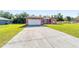 Single-Gathering home with a large, well-maintained driveway and a two-car garage at 15087 Sw 43Rd Ct, Ocala, FL 34473
