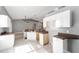 Open kitchen featuring a kitchen island, white cabinets, and stainless steel appliances at 15087 Sw 43Rd Ct, Ocala, FL 34473