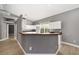 Bright kitchen featuring white cabinets, expansive bar countertop, and stainless-steel sink at 15087 Sw 43Rd Ct, Ocala, FL 34473
