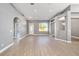 Spacious living room featuring archways, a large window, and light wood-look floors at 15087 Sw 43Rd Ct, Ocala, FL 34473