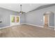 Open-concept living area featuring neutral paint, vaulted ceiling, and view of the bathroom at 15087 Sw 43Rd Ct, Ocala, FL 34473