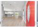Bright, open-concept living space with wood-look flooring and a view of the kitchen at 15087 Sw 43Rd Ct, Ocala, FL 34473