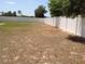 Large backyard featuring a pristine white fence, offering a secure and private outdoor space at 15266 Sw 44Th Ter, Ocala, FL 34473