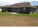 An expansive backyard features a concrete patio and lush green grass at 15266 Sw 44Th Ter, Ocala, FL 34473
