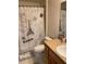 Charming bathroom with single sink vanity, toilet, and a decorative shower curtain showcasing a Parisian theme at 15266 Sw 44Th Ter, Ocala, FL 34473