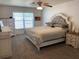 Spacious bedroom with a queen-sized bed, carpet floors, neutral colors, and window with blinds for privacy at 15266 Sw 44Th Ter, Ocala, FL 34473