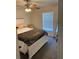Cozy bedroom with neutral tones, ceiling fan, white bed frame, and natural light from a window with blinds at 15266 Sw 44Th Ter, Ocala, FL 34473