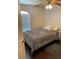 Comfortable bedroom featuring a full-sized bed, wood flooring, and ample natural light from the window with blinds at 15266 Sw 44Th Ter, Ocala, FL 34473