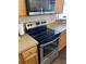 Close-up of a modern stainless steel stove with sleek countertops and wood cabinets in a well-equipped kitchen at 15266 Sw 44Th Ter, Ocala, FL 34473