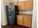 Stylish kitchen with stainless steel refrigerator complemented by wood cabinets and laminate countertops at 15266 Sw 44Th Ter, Ocala, FL 34473