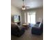 Comfortable living room with large sliding glass doors to patio, ceiling fan, and leather reclining sofa and chair at 15266 Sw 44Th Ter, Ocala, FL 34473