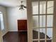 Cozy office space with hardwood floors and a ceiling fan, accessible through elegant French doors at 15266 Sw 44Th Ter, Ocala, FL 34473