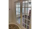 Bright office with dark wood floors, visible through glass-paned French doors from the foyer at 15266 Sw 44Th Ter, Ocala, FL 34473