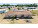 A beautiful backyard featuring solar panels on roof, a small outdoor seating area and lovely landscaping at 173 Juniper Way, Ocala, FL 34480