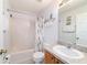This bathroom has a combined shower-tub, neutral tile, and a single sink, providing a clean and functional space at 173 Juniper Way, Ocala, FL 34480