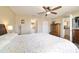 Bright bedroom features a ceiling fan, a spacious closet, and an ensuite bathroom for added privacy at 173 Juniper Way, Ocala, FL 34480