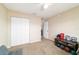 Bright bedroom featuring neutral decor, closet, and a glimpse of the dining room offering a cozy retreat at 173 Juniper Way, Ocala, FL 34480