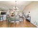 Open concept living space featuring a dining area with modern chandelier, wood flooring, and natural light at 173 Juniper Way, Ocala, FL 34480