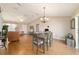 Open concept living space featuring a dining area with modern chandelier, wood flooring, and natural light at 173 Juniper Way, Ocala, FL 34480