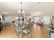 Open-concept dining room with hardwood floors, chandelier and adjacent kitchen at 173 Juniper Way, Ocala, FL 34480
