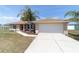 Single-story home with attached two-car garage, manicured lawn, and well-maintained landscaping at 173 Juniper Way, Ocala, FL 34480