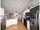 Bright kitchen with stainless steel appliances and view into dining and living spaces at 173 Juniper Way, Ocala, FL 34480